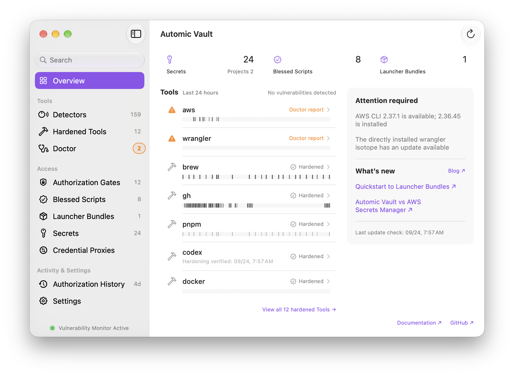 Automic Vault overview showing hardened tools including Homebrew and GitHub, with AWS and Wrangler updates needing attention